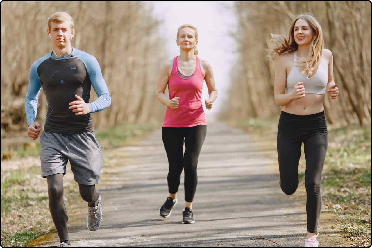 Men and women running together on a road.